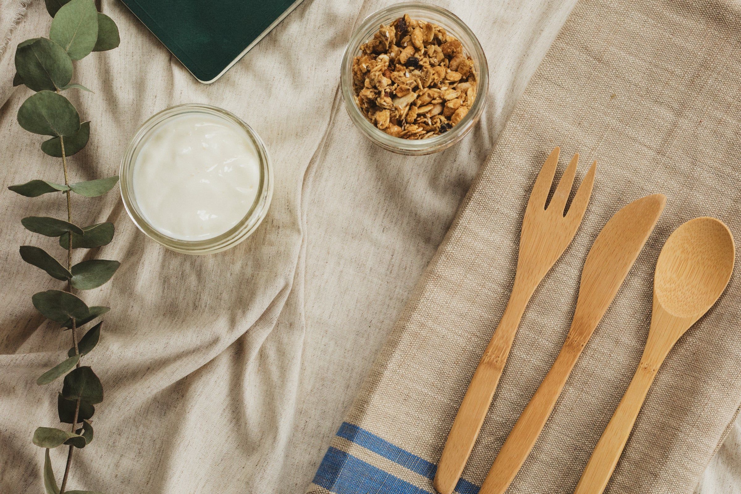 Gesundes Frühstück mit Joghurt und Müsli auf einem gedeckten Tisch